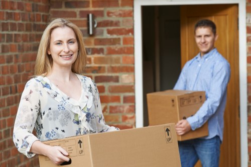 Movers carrying boxed belongings during a same day removal service