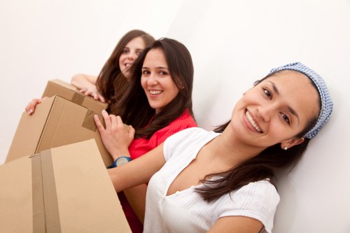 Staff member handling packed boxes during a careful removal service