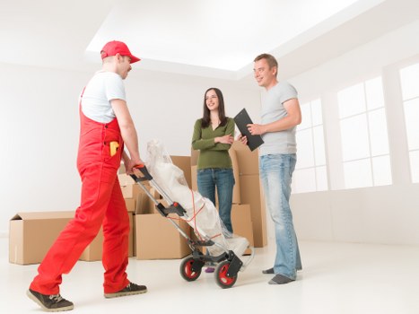 Removal team handling furniture during a local relocation in Teddington
