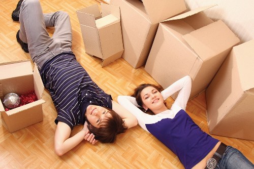 Team using protective gloves and safe lifting techniques during a move